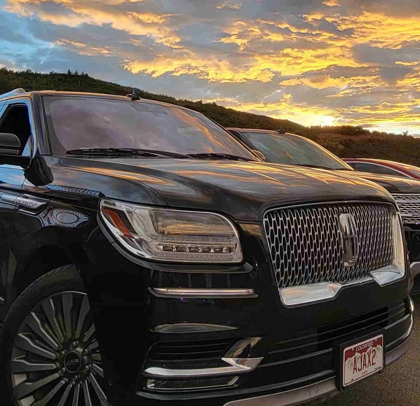 Sunset over a Black Canyon Limo vehicle